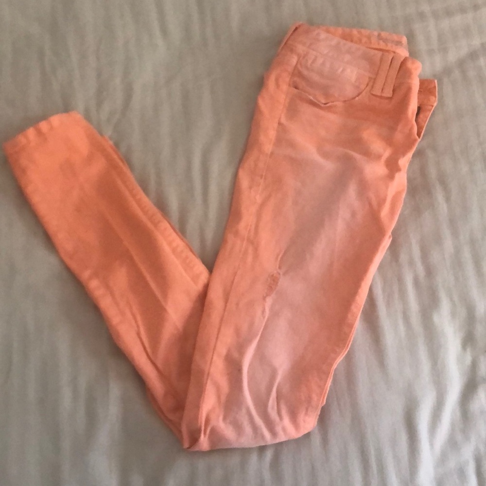 Pink American Rag “super skinny” distressed jeans.